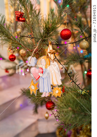 Decorated Christmas tree with toy angel in Orthodox church 71694915