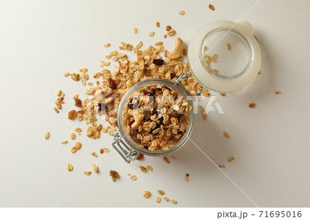 Glass jar with granola on white background 71695016