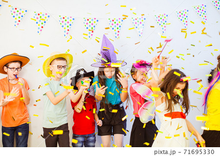 Kid's Birthday party with party horns and confetti 71695330