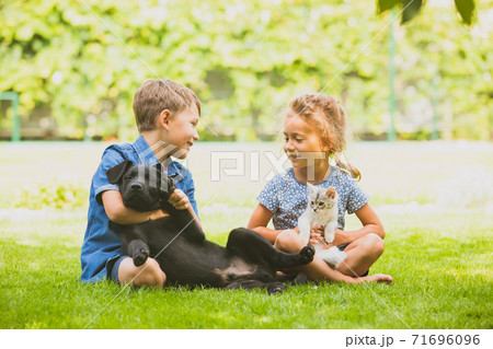 Cheerful brother and sister happily chatting in park 71696096