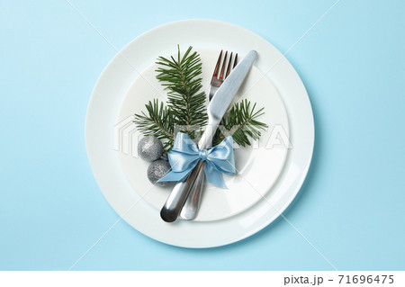 Plates with New year cutlery on blue background 71696475