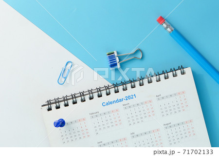 2021 calendar with pen and push pin on color background  2021 calendar with pen and push pin on color background  71702133
