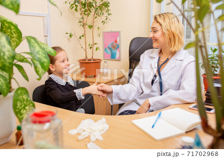 Paediatrician doctor examining a child in comfortabe medical office 71702968