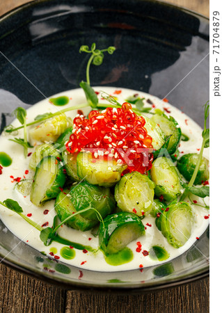 Brussels sprouts with caviar in a black bowl 71704879