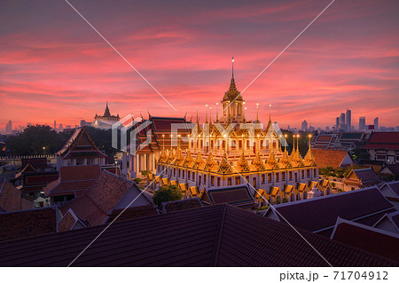 Loha Prasat Wat Ratchanatda and Golden Mountain pagoda, a buddhist temple or Wat Saket with skyscraper buildings in Bangkok Downtown, urban city, Thailand. Thai Landmark. Architecture. 71704912