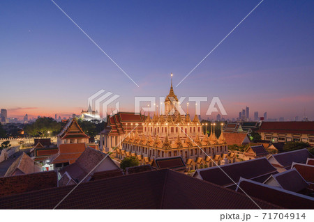 Loha Prasat Wat Ratchanatda and Golden Mountain pagoda, a buddhist temple or Wat Saket with skyscraper buildings in Bangkok Downtown, urban city, Thailand. Thai Landmark. Architecture. 71704914