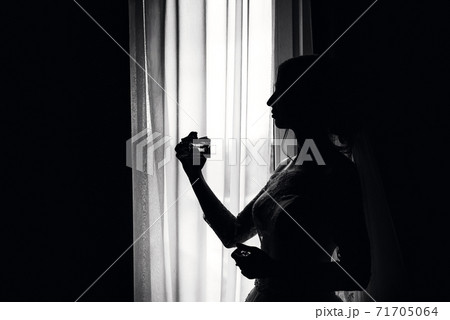 black and white silhouette of an elegant bride at the window black and white silhouette of an elegant bride at the window 71705064