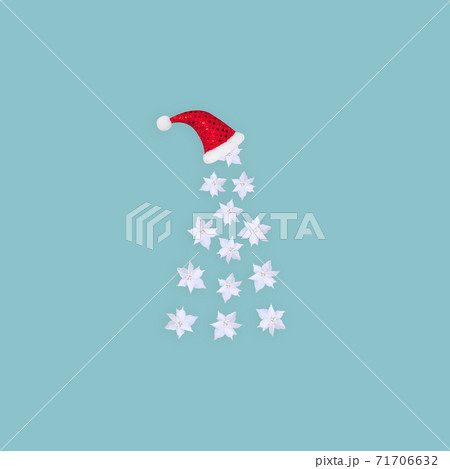 Contemporary collage. 3D illustration. Abstract Christmas background with a white tree made of flowers and in a red cap on a blue background. 71706632