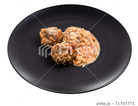 cooked meatballs with rice on plate isolated 71707771