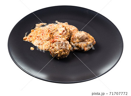 portion of meatballs with rice on plate isolated 71707772