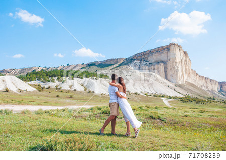 Happy family of two walking in the mountains on the sunset 71708239
