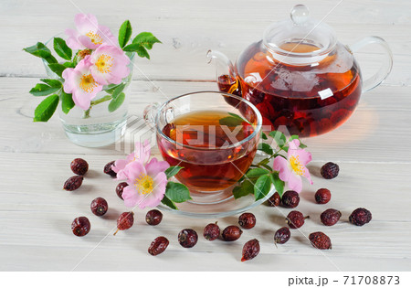 Teapot and cup of rose hip tea 71708873