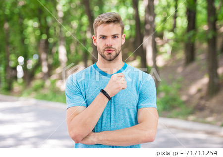 Man athlete on strict face posing with sportive equipment Man athlete on strict face posing with sportive equipment 71711254