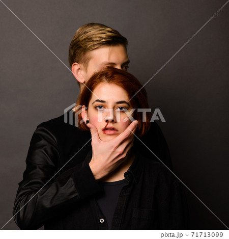 Desparate young woman with aggressive man in studio, domestic violence conception Desparate young woman with aggressive man in studio, domestic violence conception 71713099