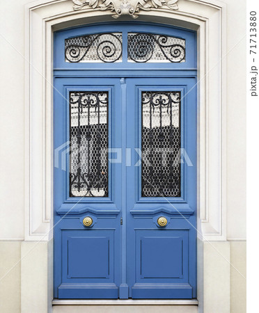 White wall of the house with a closed blue wooden door in Paris, France. White wall of the house with a closed blue wooden door in Paris, France. 71713880