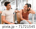 Couple man and woman in casual lifestyle talking and smiling while waiting to onboard at the airport, Happy tourist traveling concept. 71721545