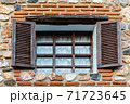 Traditional window with wooden shutters 71723645