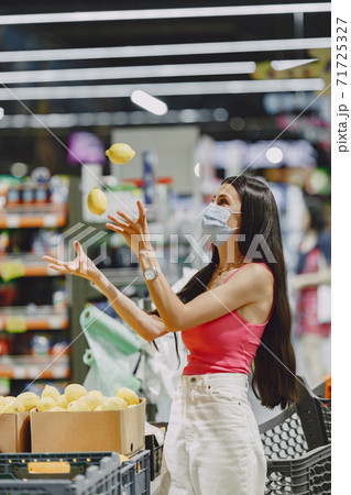 Woman in a respirator in a supermarket Woman in a respirator in a supermarket 71725327