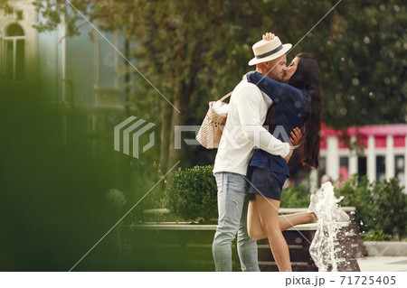 Beautiful couple spend time in a summer city Beautiful couple spend time in a summer city 71725405