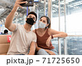 Young couple man and woman wearing face mask selfie by smartphone while waiting to on board in the airport. 71725650