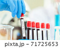 scientist in laboratory with test tubes 71725653