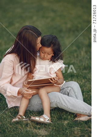 Elegant mother with daughter in a summer park 71726013