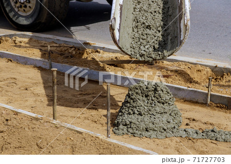Pouring cement during concrete sidewalk Pouring cement during concrete sidewalk 71727703