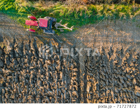 Tractor plowing fields preparing land for sowing Tractor plowing fields preparing land for sowing 71727872