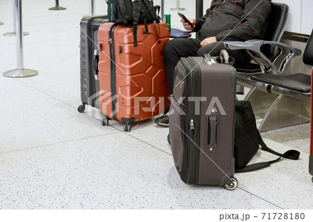Busy man on phone in airport suitcases in the airport departure lounge 71728180