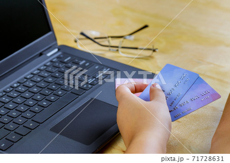 E-commerce hand holding credit card using laptop spending money online shopping internet E-commerce hand holding credit card using laptop spending money online shopping internet 71728631