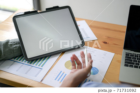 Cropped shot of Employees presenting with tablet in office. 71731092