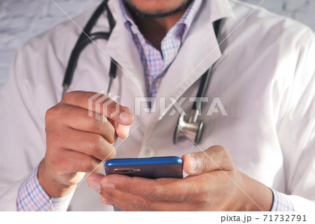 Close up of doctor hand using smartphone in the hospital. Close up of doctor hand using smartphone in the hospital. 71732791
