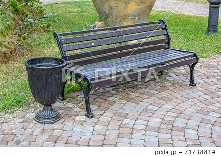 Comfortable wooden bench in the city park 71738814