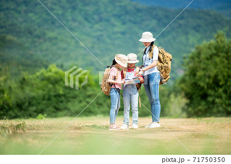 Group family children checking map in the jungle adventure 71750350