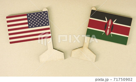Two flags of the USA and Kenya made of recycled paper on the cardboard desk, flat layout 71750902