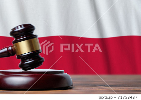 Justice and court concept in Republic of Poland. Judge hammer on a flag background 71753437