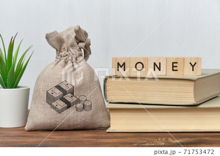 Money concept with a bag of money and books. Money concept with a bag of money and books. 71753472