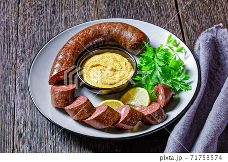 Blutwurst or german blood sausage on a plate Blutwurst or german blood sausage on a plate 71753574