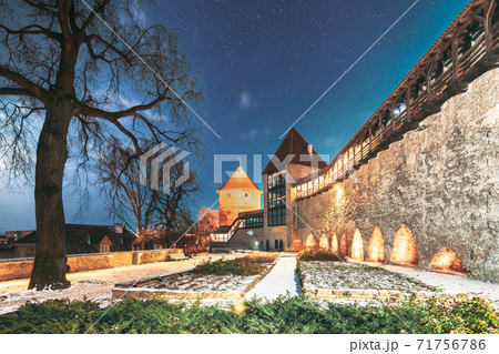Tallinn, Estonia. Night Starry Sky Above Traditional Old Architecture Skyline In Old Town. Former Prison Tower Neitsitorn In Winter Evening Night. Famous Landmark. Altered Sky With Stars 71756786