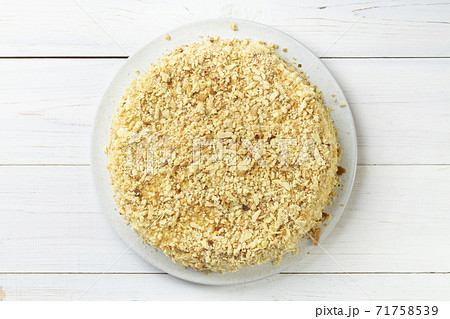 Homemade honey cake with sour cream on a white wooden table. Space for text. 71758539