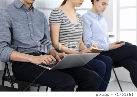 Group of casual dressed business people working at meeting or conference, close-up of hands. Businessman using laptop computer. Teamwork or coaching concept 71761361