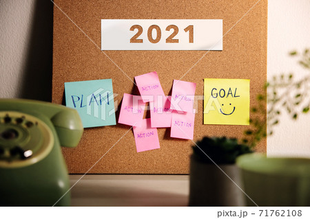 Goal, Plan, Challenge and Strategy for 2021 Year Concept. Sticky Note on Cork Board on Working Desk. Closeup and Selective Focus on Goal Text 71762108