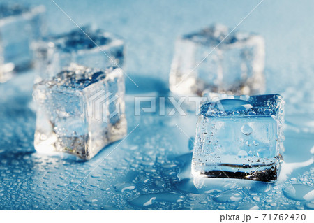 Blocks of Ice With water Drops close-up. Macro ice refreshing cube for a drink on a hot day Blocks of Ice With water Drops close-up. Macro ice refreshing cube for a drink on a hot day 71762420