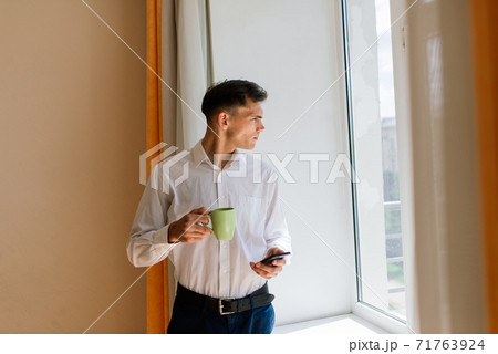 Relaxed young man resting from work. Man enjoy break stretching in home office workplace, isolation 71763924