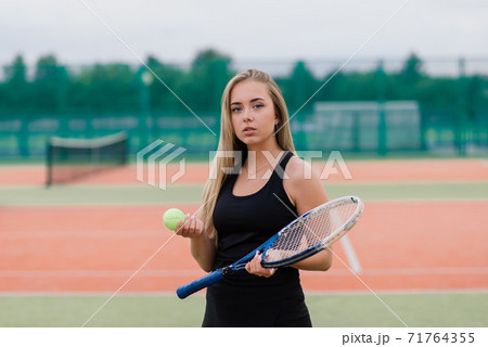 Tennis tournament. Female player at the clay tennis court 71764355