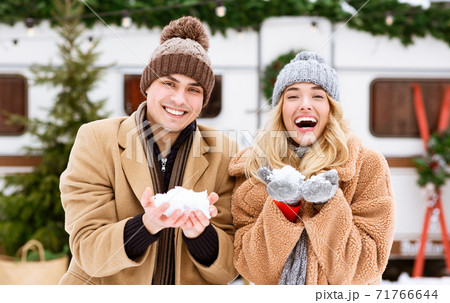 Young Romantic Couple Playing With Snow, Having Fun Outdoors At Winter Day 71766644