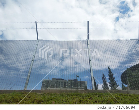 MELAKA, MALAYSIA -JUNE 5, 2020: Anti-climb fencing made from galvanized iron install at the perimeter or property boundary to prevent from the intruder. Its close nets can prevent intruders from climb MELAKA, MALAYSIA -JUNE 5, 2020: Anti-climb fencing made from galvanized iron install at the perimeter or property boundary to prevent from the intruder. Its close nets can prevent intruders from climb 71766694