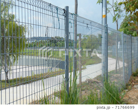MELAKA, MALAYSIA -JUNE 5, 2020: Anti-climb fencing made from galvanized iron install at the perimeter or property boundary to prevent from the intruder. Its close nets can prevent intruders from climb 71766699