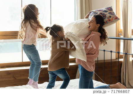 Young mother play battle with two cute daughters Young mother play battle with two cute daughters 71766807
