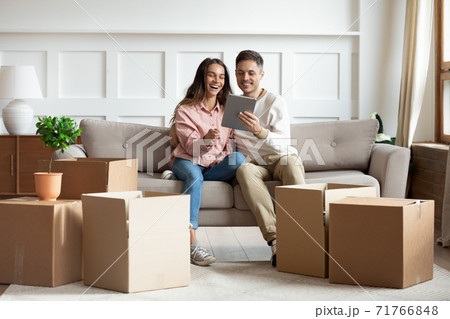 Couple buying furniture for new house using tablet device Couple buying furniture for new house using tablet device 71766848